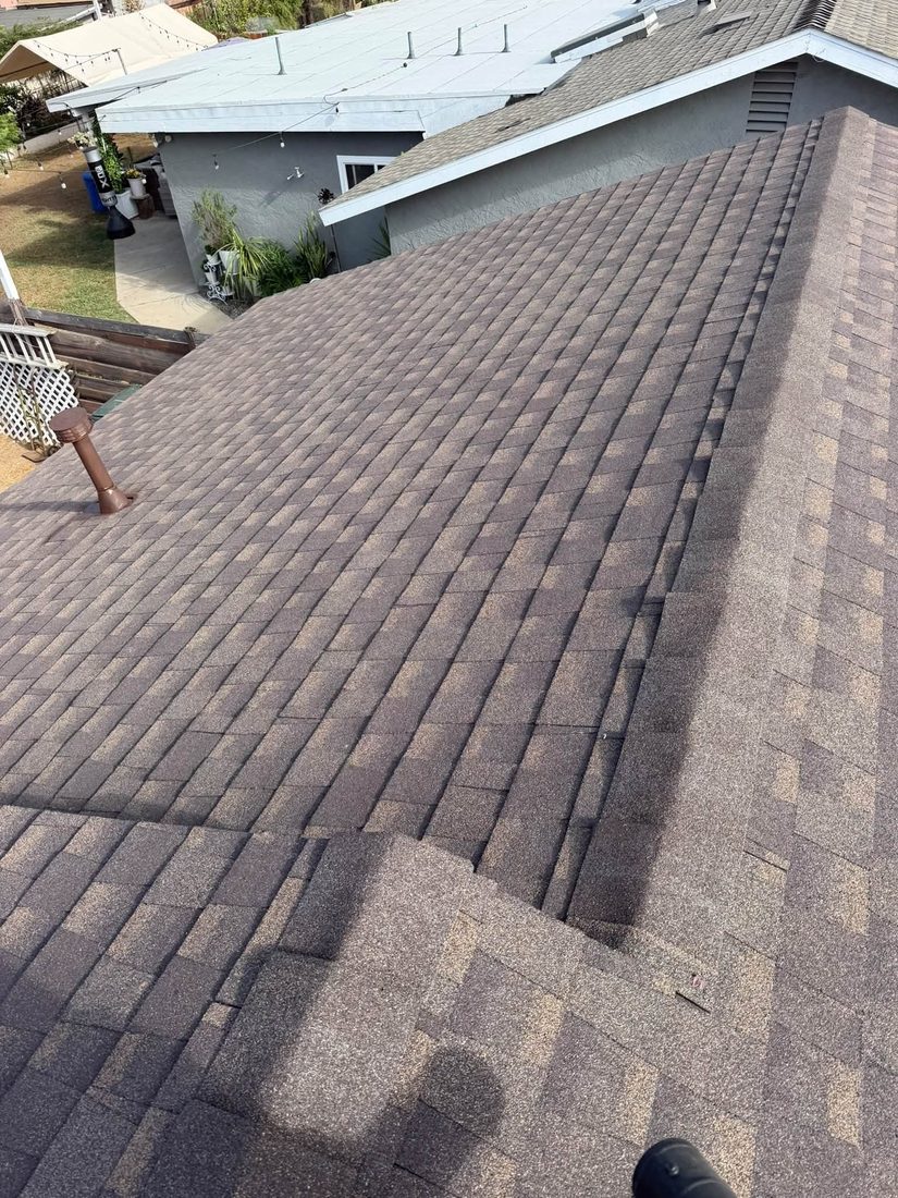 Dark shingle roof with ridge vent
