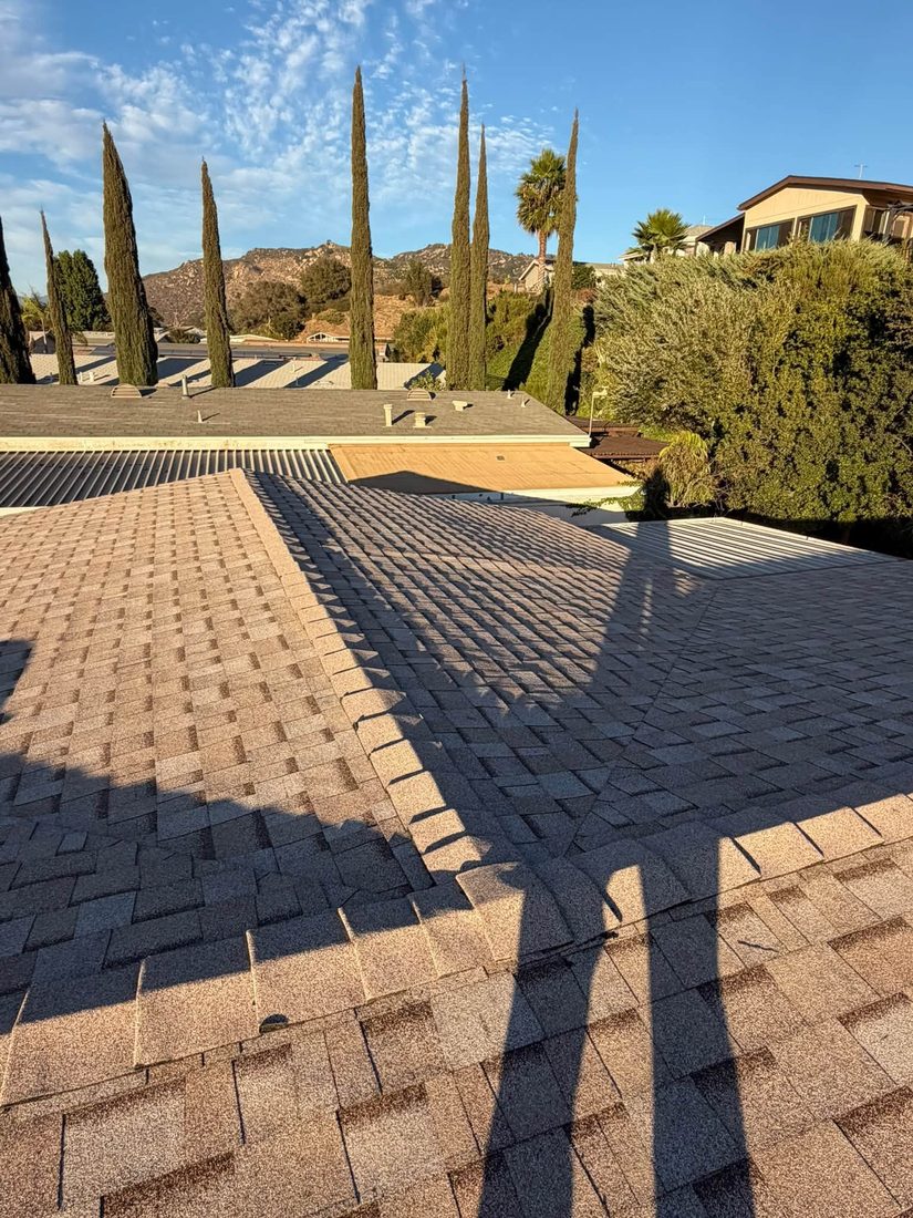 Tan shingle roof with a straight ridge