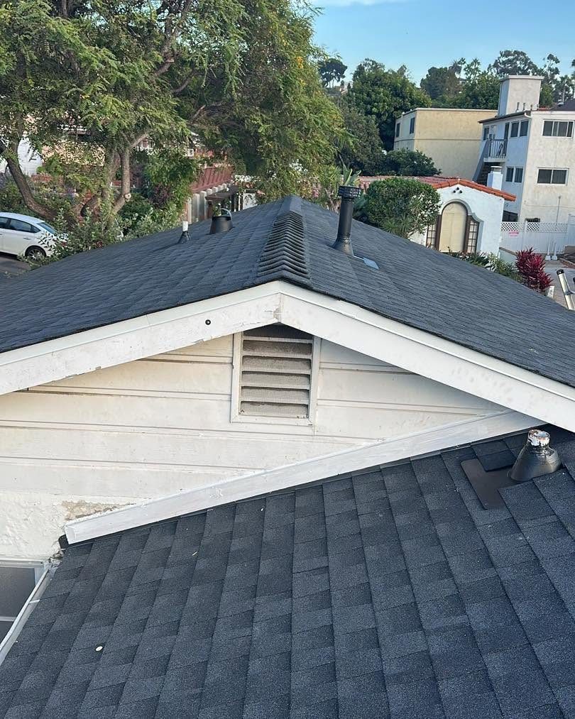 Finished dark shingle roof over a gable with vents