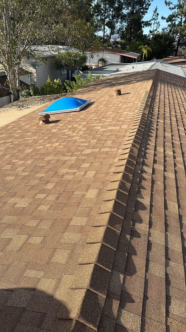 Shingle ridge line running past a skylight