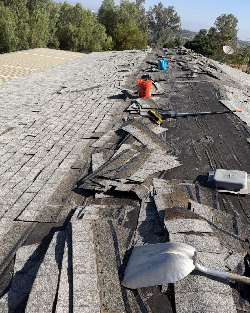 Old shingles being torn off a roof